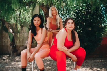 three sitting girls in red