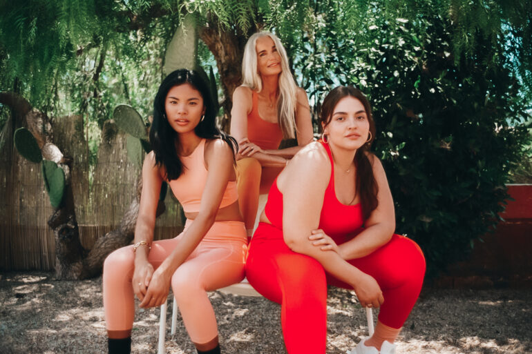 three sitting girls in red