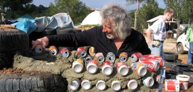 Photo of Michael Reynolds building one of his houses out of recycled cans. Photo: Garbage Warrior / Oliver Hodge.